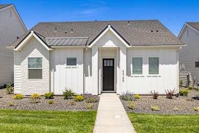 A white house with a black door and windows.