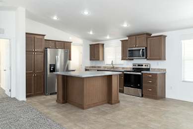 A kitchen with brown cabinets and stainless steel appliances.
