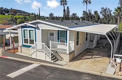 A house with a blue door and white railings.