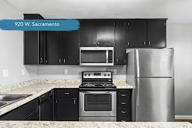 Modern kitchen with black cabinets and stainless steel range at OSM Properties Homes & Apartments, California, 95926