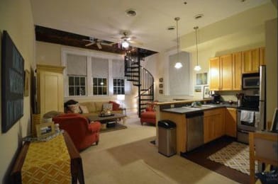 a living room filled with furniture and a kitchen
