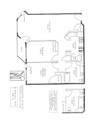 A floor plan of an apartment with a living room, two bedrooms, a bathroom, and a kitchen.