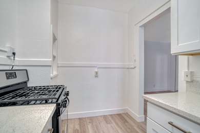 A kitchen with a stove top oven and a counter top at Clay & Tiffany, Portland, 97201