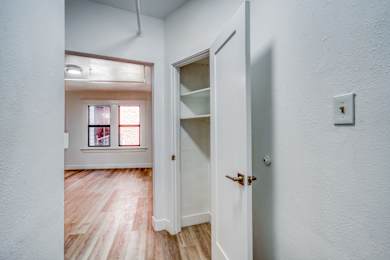 A white door with a shelf and a light switch on the wall at Clay & Tiffany, Portland, 97201