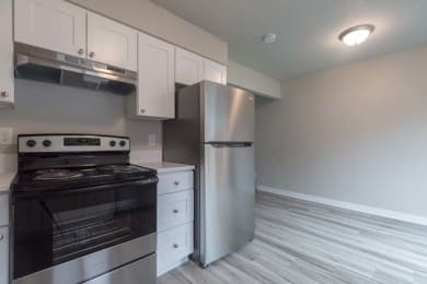 a kitchen with a stove and a refrigerator