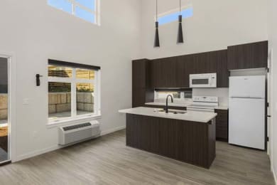 a kitchen with a sink a stove and a refrigerator