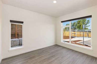 an empty room with a large window and a wooden fence
