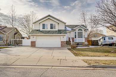 A house with a white garage door is in the foreground.