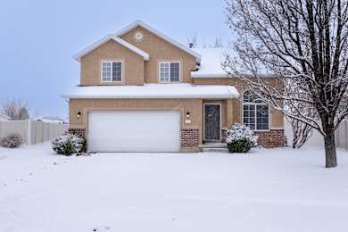 A house with a white garage door and a brown roof.