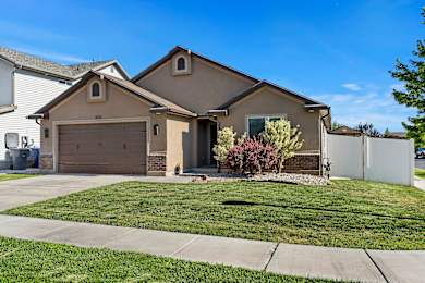 A house with a brown roof and a white garage door.