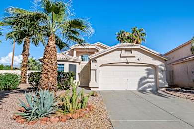 A house with a palm tree in front.
