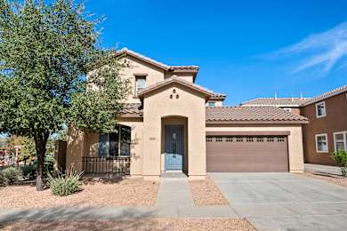 A house with a blue door and a garage door.