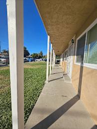 a view of the outside of a building with a sidewalk