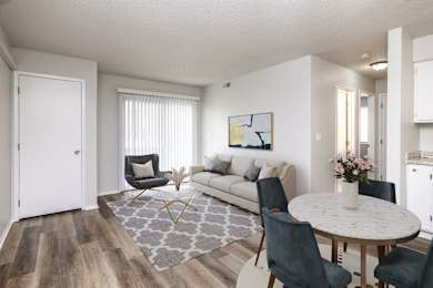 A living room with a grey rug and a white table.at Fish Creek, Iowa