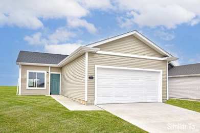 A house with a garage door and a window is shown. at Two Rivers Home Rentals, West Des Moines, 50266