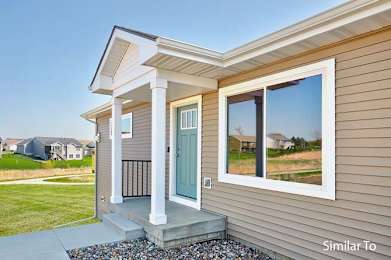 a house with a blue door and a large window at Two Rivers Home Rentals, West Des Moines, 50266