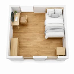 A bedroom with a bed, desk, and chair.