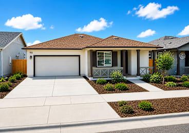 A house with a brown roof and a white garage door.