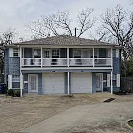A blue house with a white garage door.