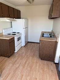 A white stove with a microwave on top of it.