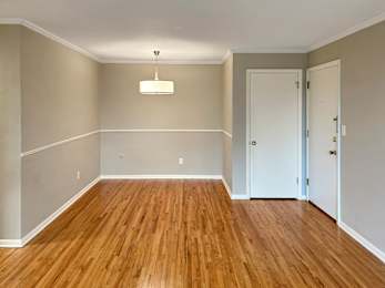 A room with wooden floors and white walls.