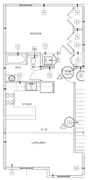 A floor plan of a small apartment with a bedroom, living area, and kitchen.