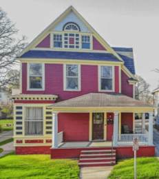 A two-story house with a red and blue exterior.