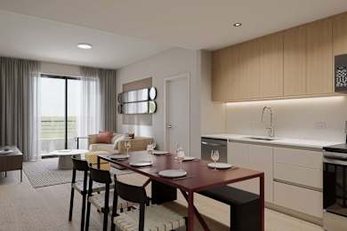 A modern kitchen with a dining table set for two.