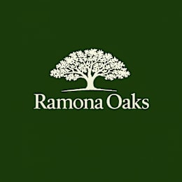 A logo with a tree and the text "Ramona Oaks" on a green background.