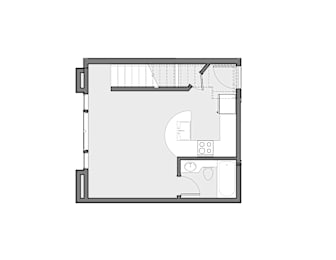 Floor Plan  A floor plan of a small apartment with a kitchen, living room, and bathroom.