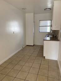 A kitchen area with a sink and a window.