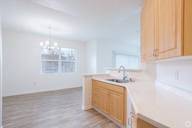 A kitchen with wooden cabinets and a white countertop.
