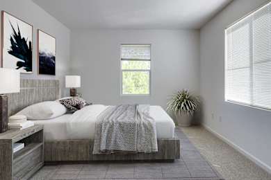 a bedroom with a bed and two windows at Cornerstone at Gale Ranch Apartments, San Ramon
