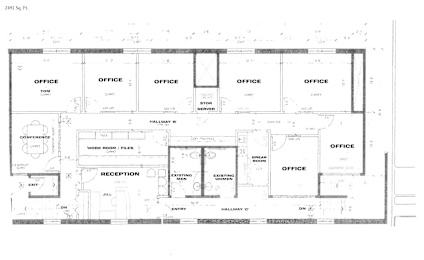 A floor plan of an office building with multiple office spaces and a reception area.