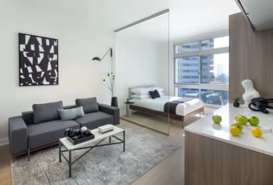 Floor Plan  a living room with a couch and a table  and a bed