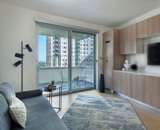 Floor Plan  a living room with a couch and a tv and a balcony