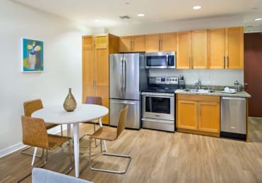 Floor Plan  a kitchen with stainless steel appliances and a table