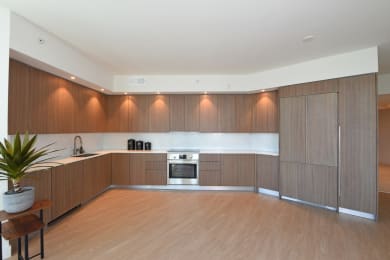 Floor Plan  a large kitchen with wooden cabinets and a wooden floor