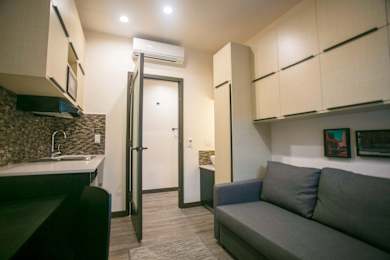 a small living room and kitchen in a small apartment