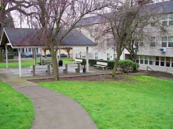 a park with benches in front of a building