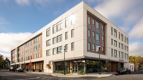 A modern building with a white facade and large windows.
