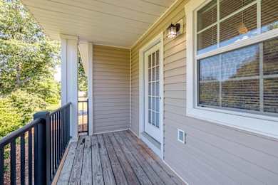 the deck of a home with a large window and a black railing at Sterlington Apartments, Georgia