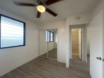 Floor Plan  an empty room with a ceiling fan and a mirror