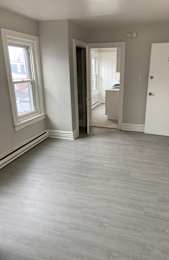 A room with a grey floor and white walls.