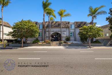 A building with palm trees in front of it and the words "Beach Front Property Management" on the bottom left.