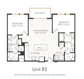 Two-bedroom apartment with entry into the kitchen featuring an island and adjacent living/dining area with balcony access. Split-bedroom layout with each bedroom offering direct bathroom access and nearby closet space. Primary bedroom includes dual vanities. In-unit washer and dryer included.