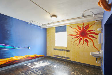 a mural of a sun on the wall of a room at MILEPOST 5 Apartments, PORTLAND, 97213