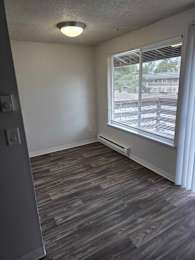 Floor Plan  A room with a window and a grey floor.