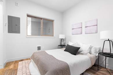Floor Plan  A bedroom with a bed, nightstand, and two lamps.