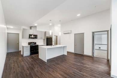 a kitchen and dining area in a 555 waverly unit